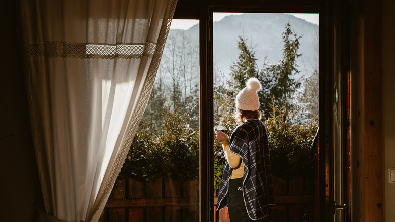 Woman enjoying a hot cup of tea on terrace in mountains