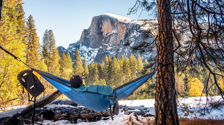 Man in hammock overlooking Half Dome in Yosemite National Park