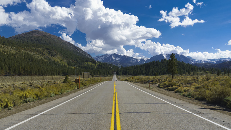 The start of the June Lake Loop, California, with two lanes of road surrounded by mountain scenery