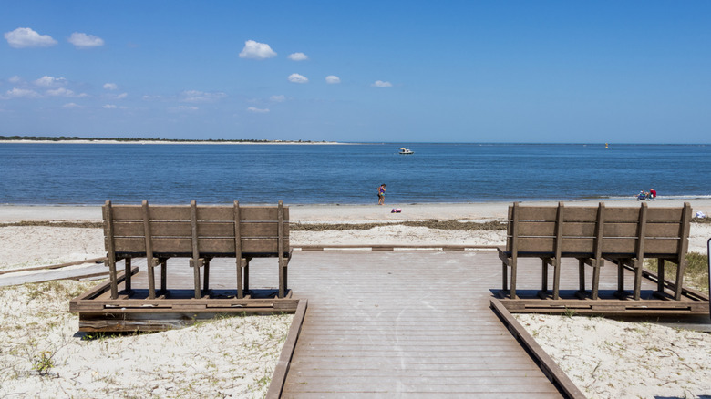 A wooden deck with benches overlooking the ocean on the beach at Fort Clinch State Park, Florida