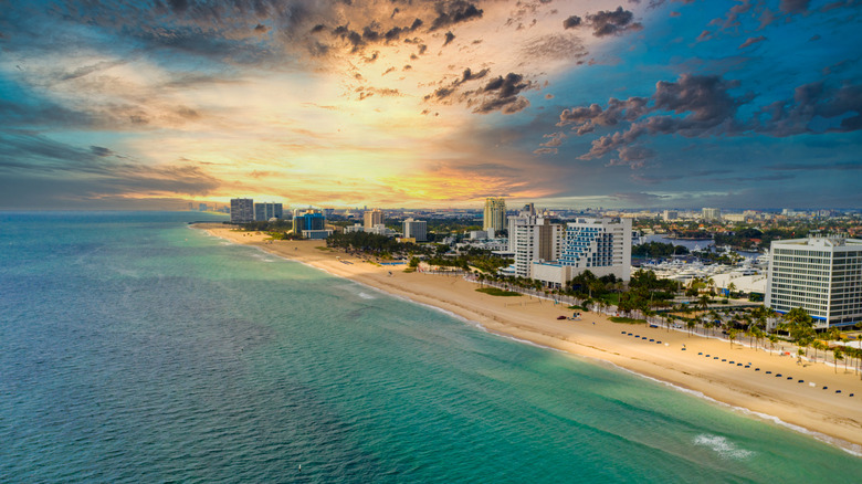 Aerial view of Ft. Lauderdale with ocean, coastline, and high-rise buildings.