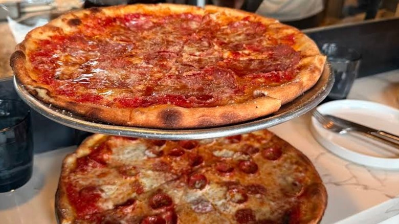 Two pizza's on a pizza stand at Heritage