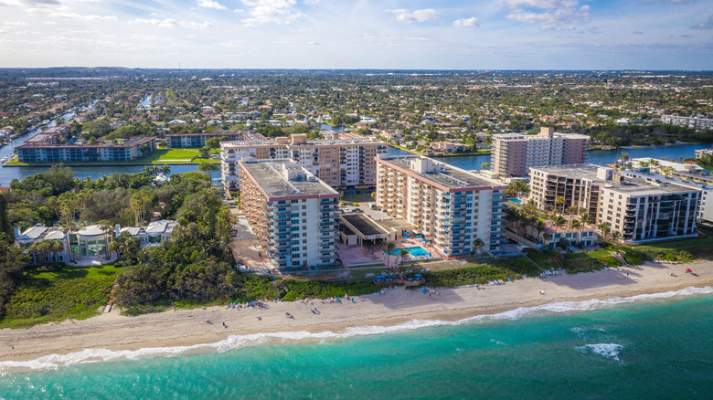 Aerial view of Lighthouse Point, Florida showing buildings, trees, and the beach