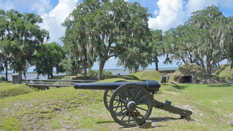 Views of Fort McAllister State Park in Georgia, featuring a canyon, earthwork forts, and oak trees, set along a scenic river