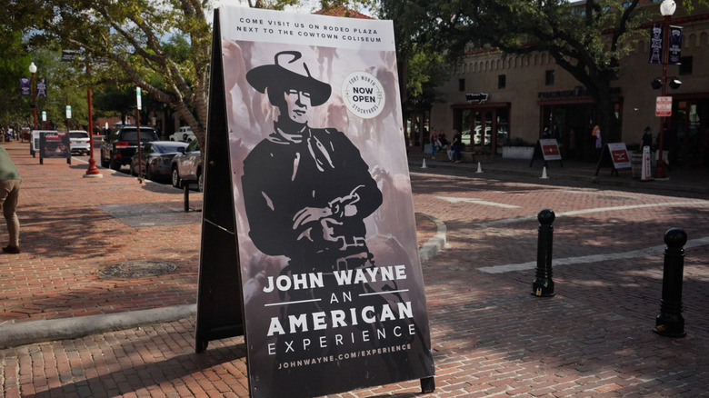 A promotional sign on a street in Fort Worth for the John Wayne: An American Experience museum.