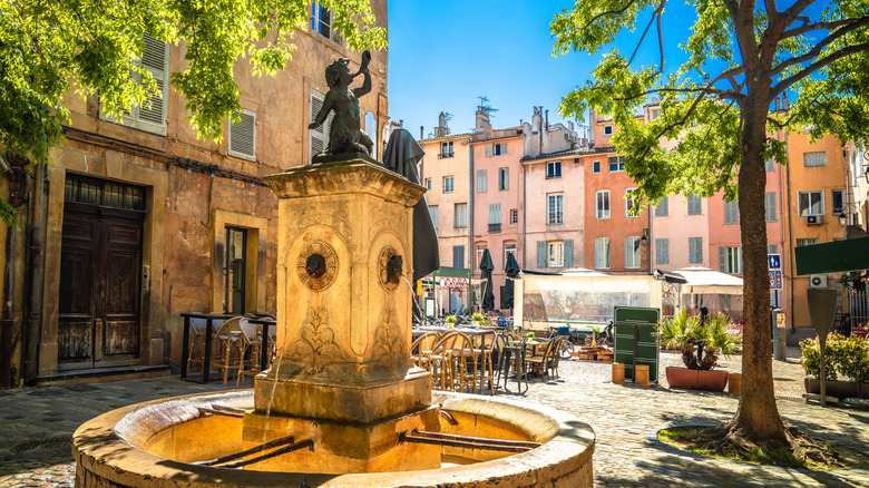 Quintessential European town square with a fountain surrounded by colorful buildings, Aix-en-Provence