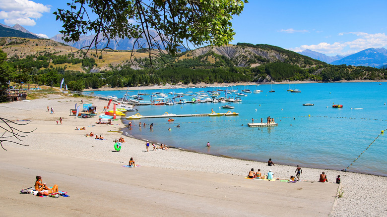 The beach at Saint-Michel Bay located on France's largest artificial lake, Lac de Serre-Ponçon, in the French Alps