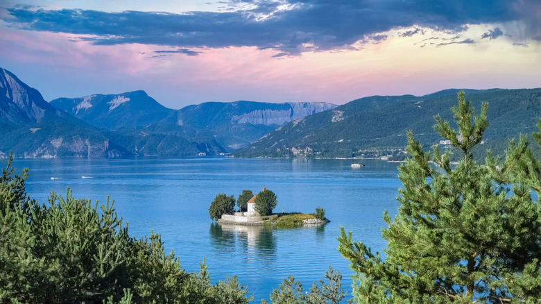 Saint-Michel Chapel located in the middle of Lac de Serre-Ponçon surrounded by the French Alps