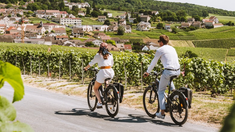 Two guests ride bikes through the countryside near the Royal Champagne Hotel & Spa