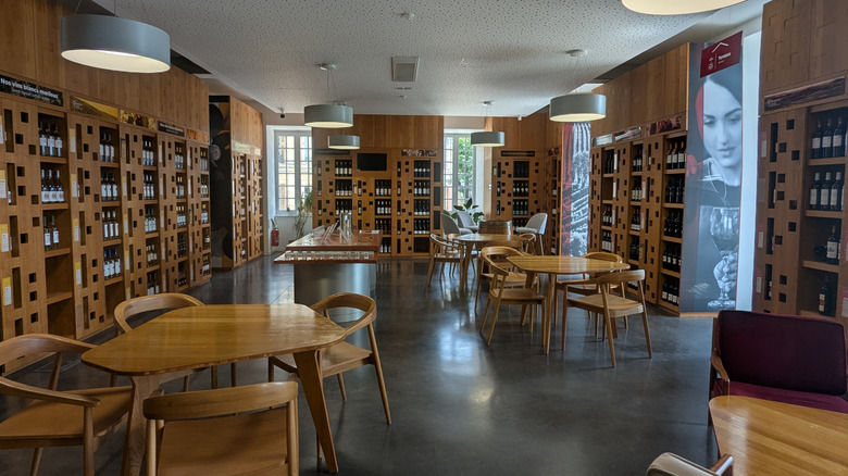 Wooden wine bar with shelves of bottles