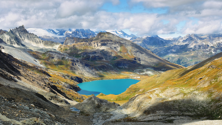 A gleaming blue lake sits between high alpine ridges in Vanoise National Park