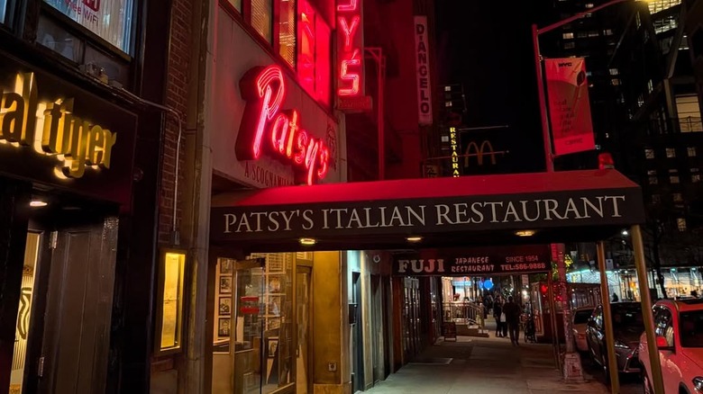 Exterior of Patsy's with neon sign lit-up at night