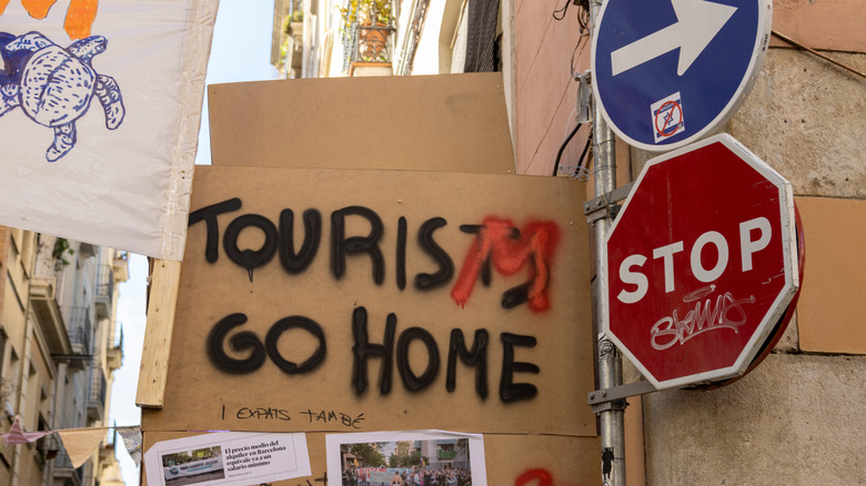 An anti-tourism sign at a protest in Barcelona, Spain