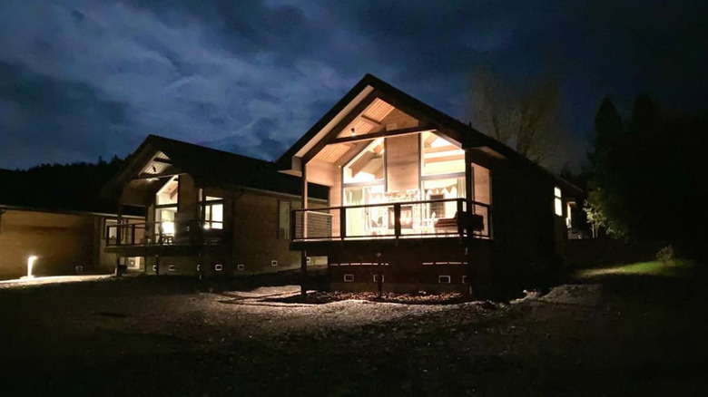 Outside of two cottages at night time
