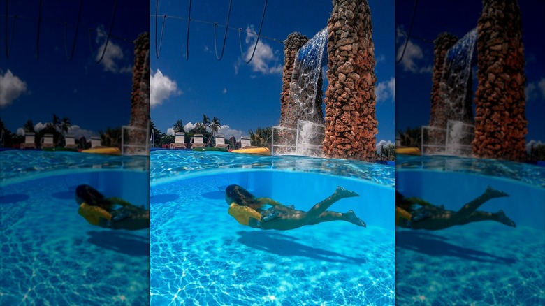 Woman swimming underwater at park