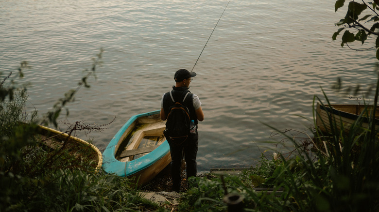 A young man fishing in a river