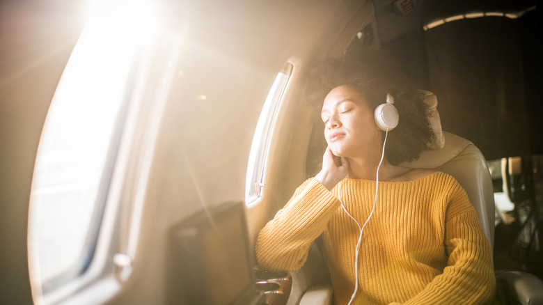 Woman relaxing on plane