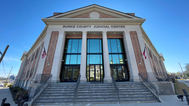External view of the Burke County Judicial Center with its Romanesque pillars, glass, and bricks