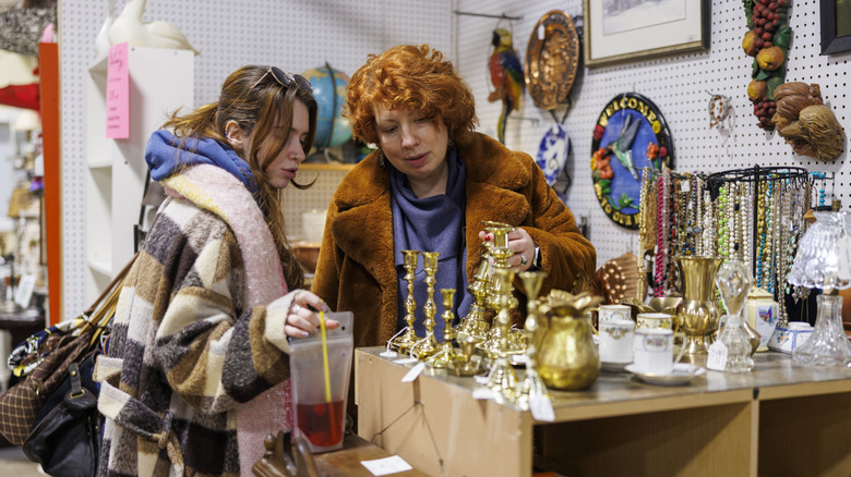 Mother and daughter shop for antiques at a store