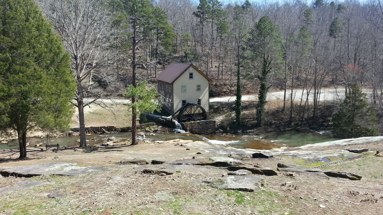 A small park in Hoschton, Georgia, with a mill house tucked between trees