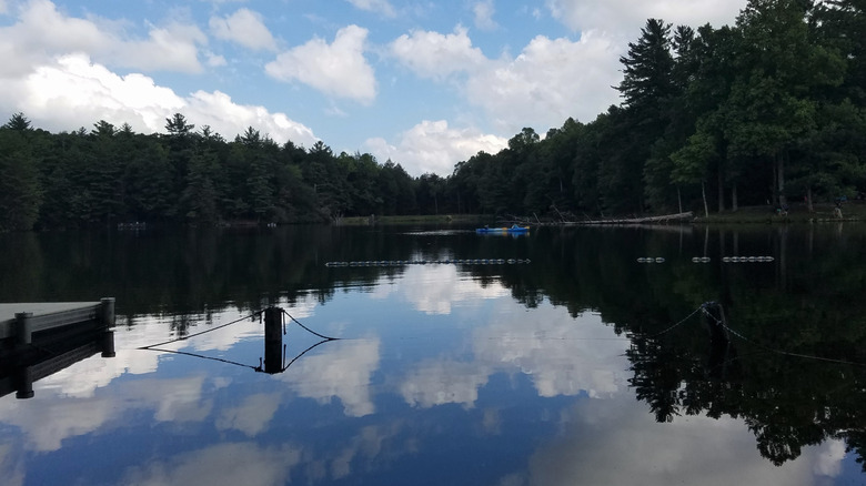 People fishing in kayaks on Lake Conasauga during a cloudy day.