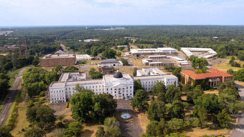A historic white building surrounded by trees in Milledgeville