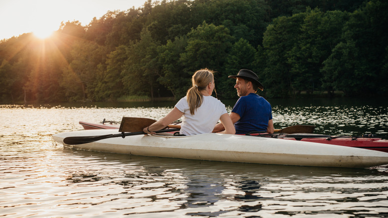 a couple canoeing on a calm lake
