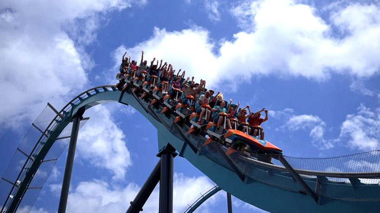 Riders put their hands up on a roller coaster at Six Flags Over Georgia