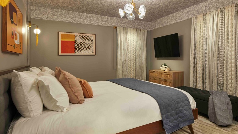 A refurbished bedroom with comfortable bedding at the New South Motor Inn
