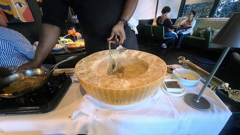A parmesan cheese wheel on a pasta cart at Tre Vele resturant