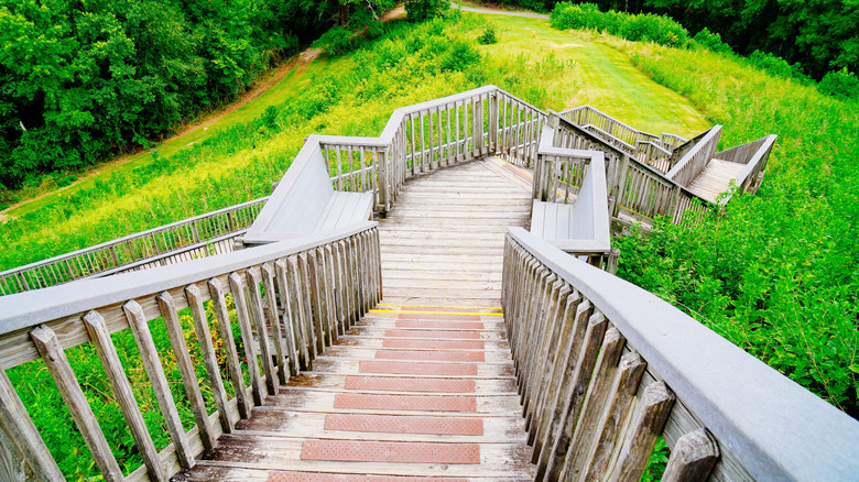 Wooden staircases to climb the mounds at Ocmulgee Mounds National Historical Park on a bright day in the spring.