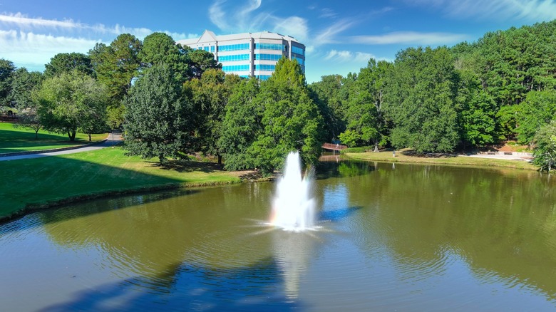 A water fountain, trees, and blue sky in Brookhaven, Georgia