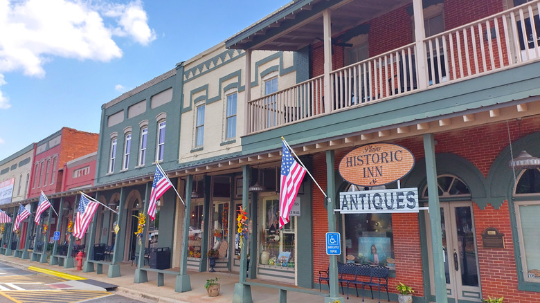 Storefronts displaying American flags in Downtown Plains, Georgia