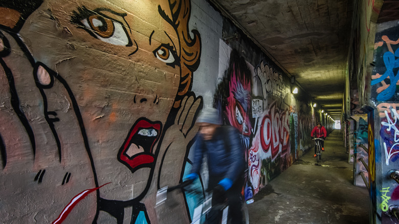 Cyclists passing through Krog Street Tunnel in Atlanta