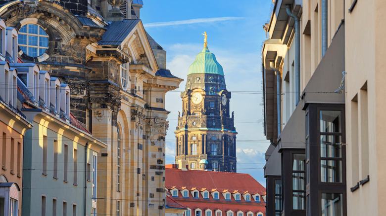 Clock tower in Dresden, Germany at the end of a historic street