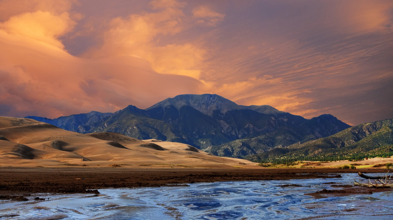 Great Sand Dunes National Park with Medano Creek under an orange sky