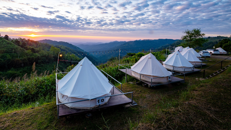 Luxury dome tents for camping and with a landscape on hill