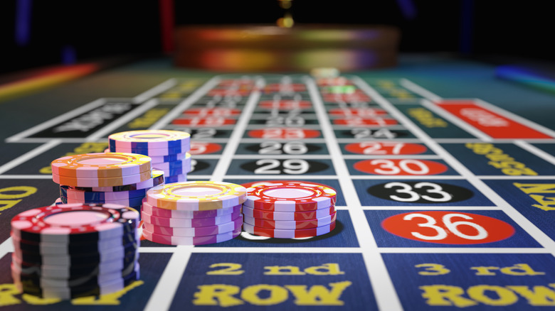 A roulette table with chips in a casino