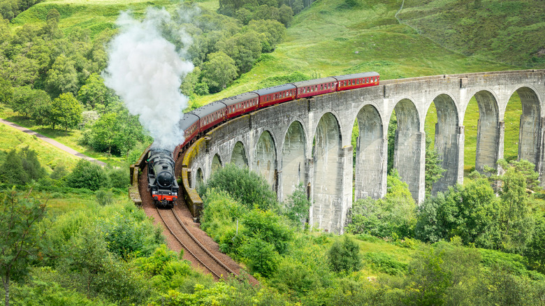 The Jacobite steam train, which stood in for the Hogwarts Express in the "Harry Potter" film series, passing through the Glenfinnan viaduct in the lush Scottish Highlands