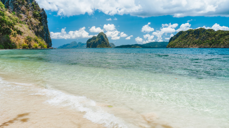 Bacuit Bay islands are visible from the shallow beaches of Lagen Island