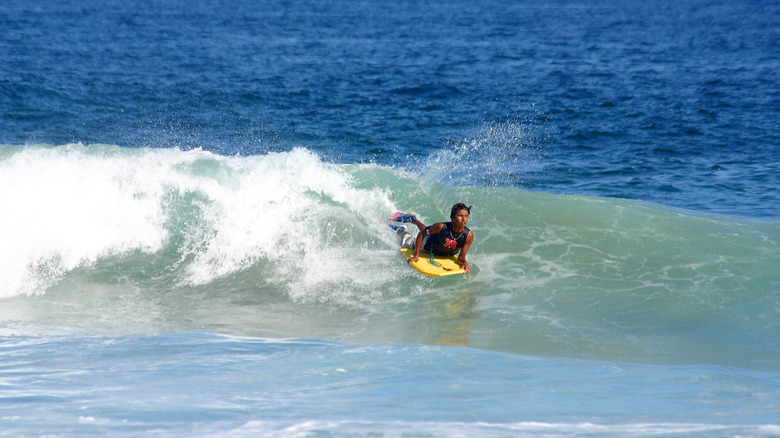 A surfer catches a wave at San Agustinillo beach
