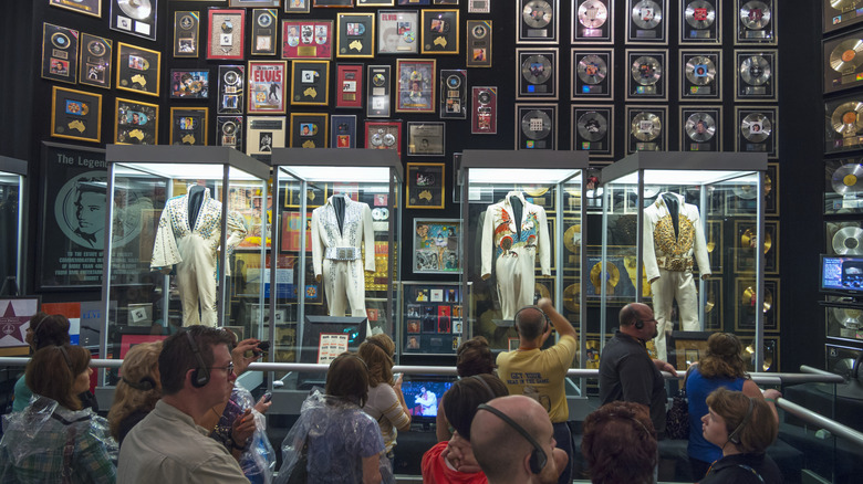 Graceland Elvis costumes records with crowd of people