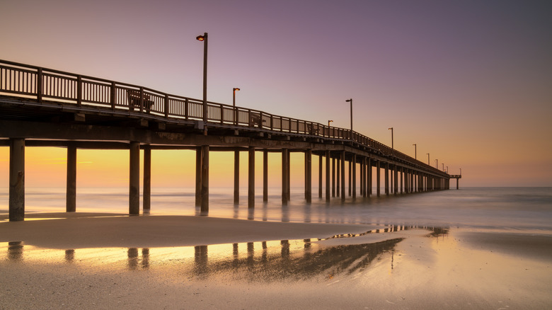 Springmaid Beach Pier stretching out over the water during sunset on a clear day
