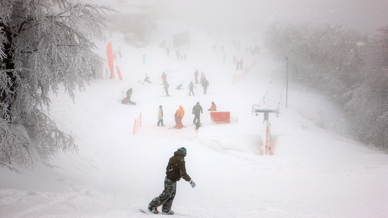 View of skiers on the Pelion ski slopes in snowy weather