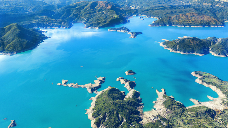 An aerial view of Lake Kremasta, ringed by rocky and verdant land in the Agrafa Mountains in Central Greece