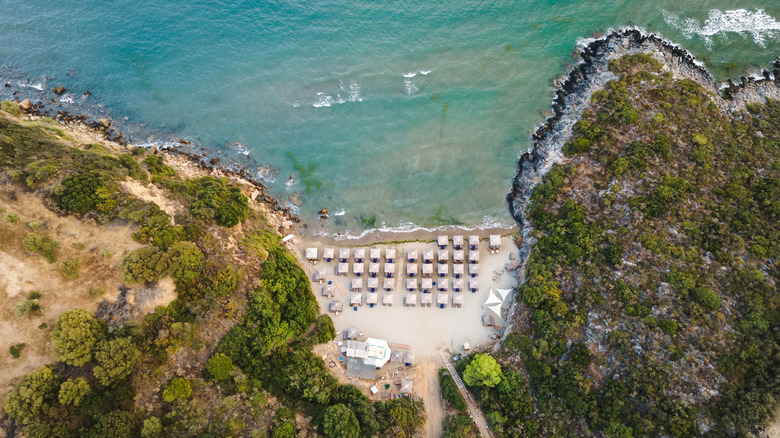 Umbrellas dot the sands of a beach in Laconia