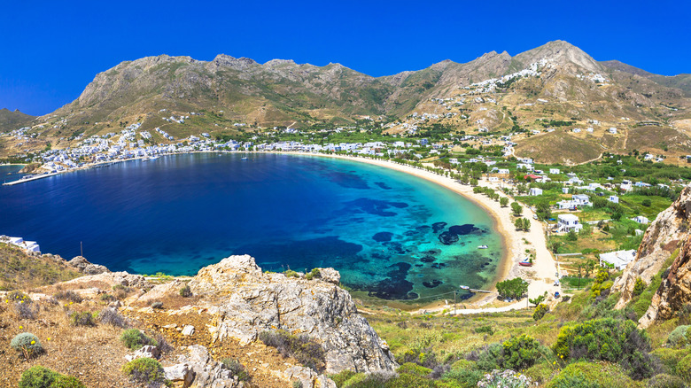 Hills of Serifos, Greece, rise from golden sand and turquoise water