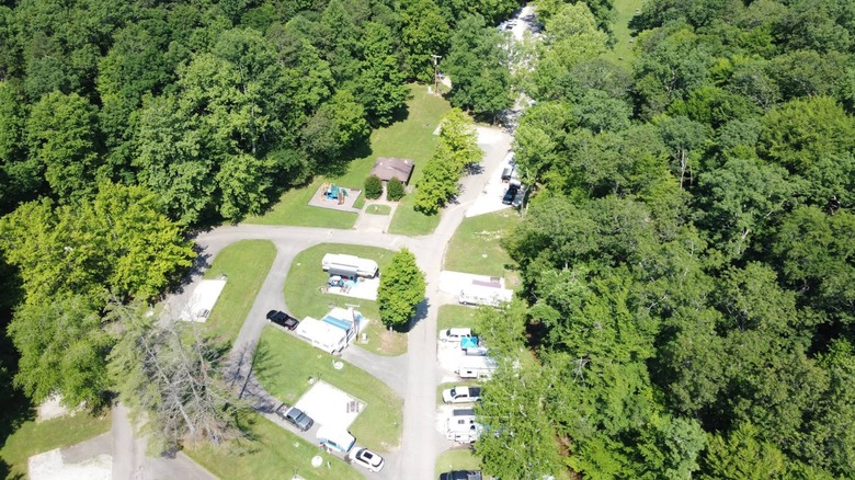 An overhead view of the campground at Greenbo Lake State Resort Park with trees, RVs, and hills visible.