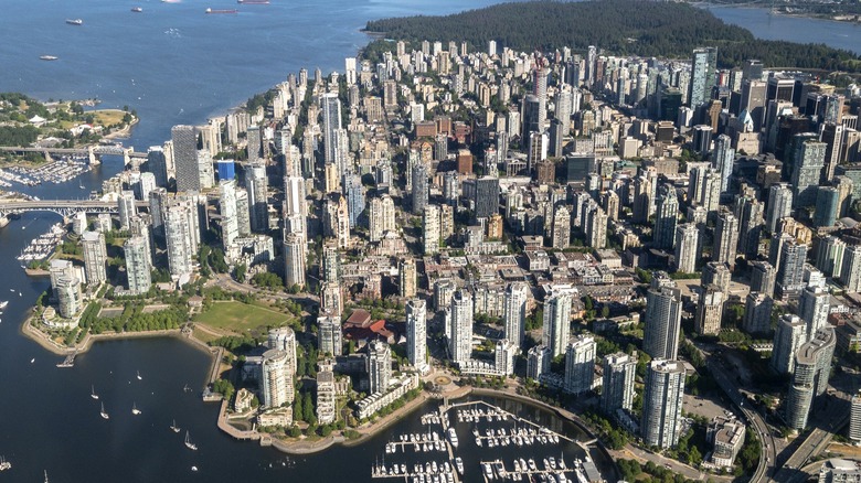 Aerial view of Vancouver showing downtown skyscrapers surrounded by water and mountains
