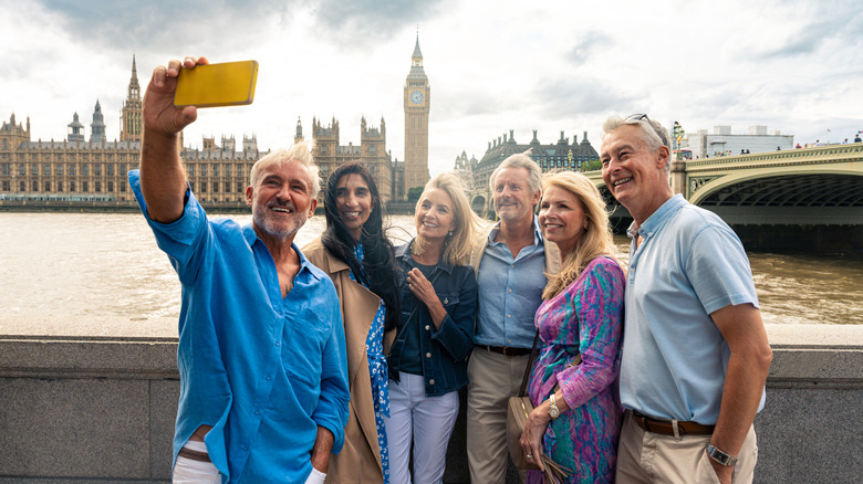 Baby boomers taking a picture in front of Big Ben in London
